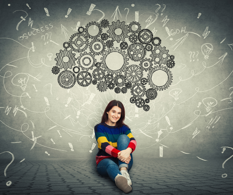 siedząca kobieta na podłodze i nad jej głową obraz mózgu człowieka złożony z małych symbolicznych kółek.
